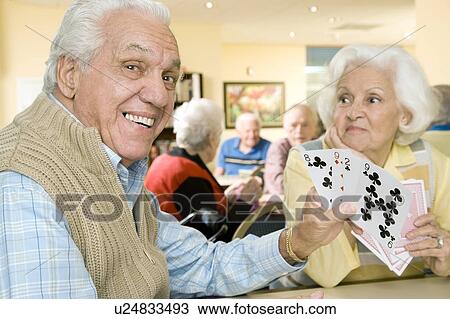 Two residents in a retirement home playing cards View Large Photo Image Stock Image - Two residents in a retirement home playing cards. Fotosearch