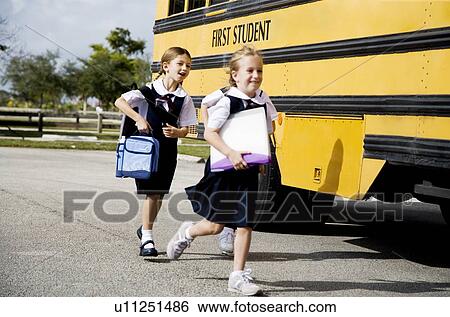 Two schoolgirls running for the school bus View Large Photo Image Stock Photograph - Two schoolgirls running for the school bus. Fotosearch