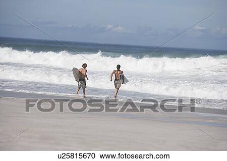 Two surfers View Large Photo Image Stock Image - Two surfers. Fotosearch