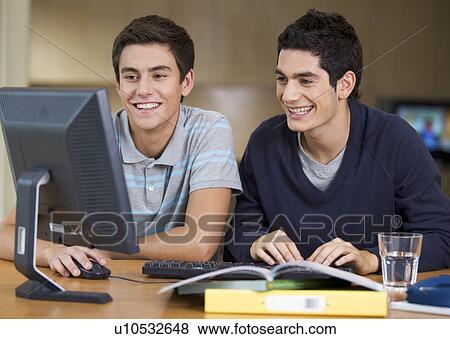 Two teenage boys studying using a computer View Large Photo Image Stock Photo - Two teenage boys studying using a computer. Fotosearch
