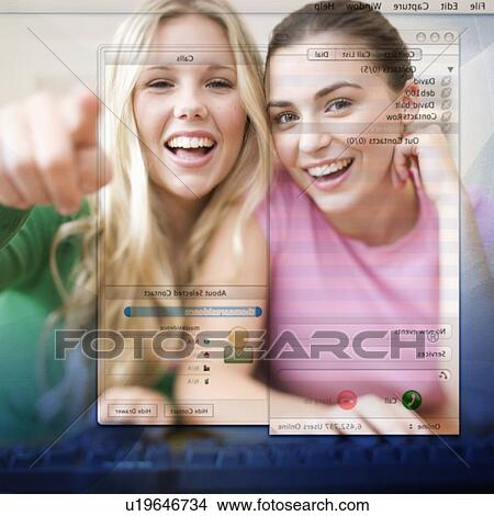 Picture - Two teenage girls using a computer. Fotosearch