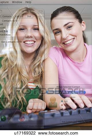 Two teenage girls using a computer View Large Photo Image Stock Image - Two teenage girls using a computer. Fotosearch