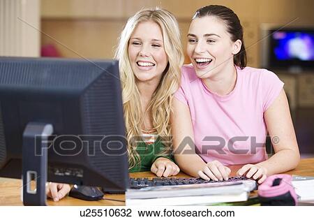 Two teenage girls using a computer View Large Photo Image Stock Image - Two teenage girls using a computer. Fotosearch
