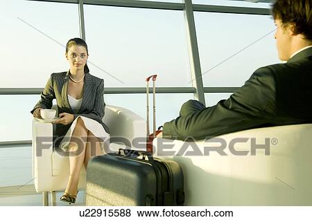 Two travellers at an airport View Large Photo Image Stock Photo - Two travellers at an airport. Fotosearch