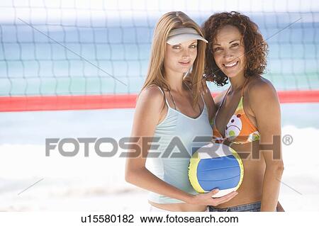 Two women playing beach volleyball View Large Photo Image Stock Image - Two women playing beach volleyball. Fotosearch