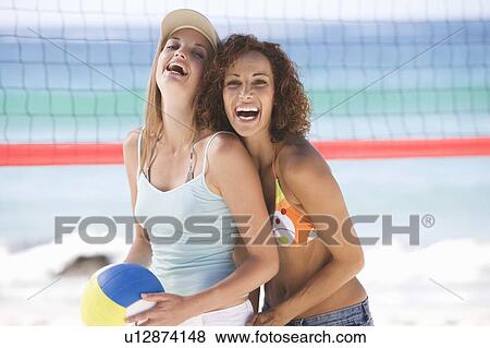 Two women playing beach volleyball View Large Photo Image Stock Photo - Two women playing beach volleyball. Fotosearch