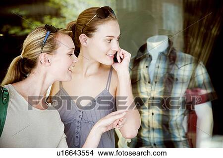 Two women window shopping View Large Photo Image Picture - Two women window shopping. Fotosearch
