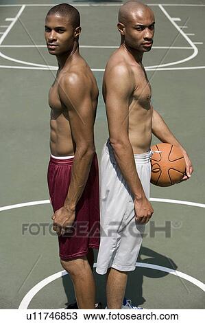 Two Young African American standing back to back on an urban basketball court View Large Photo Image Stock Image - Two Young African American standing back to back on an urban basketball court. Fotosearch