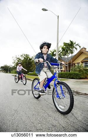 Stock Image - Two young children on bikes. Fotosearch