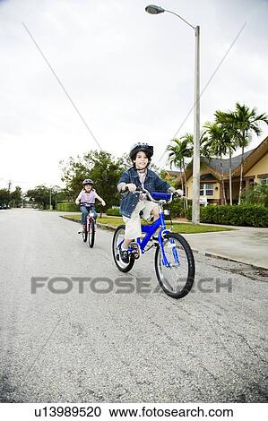 Two young children on bikes View Large Photo Image Stock Image - Two young children on bikes. Fotosearch
