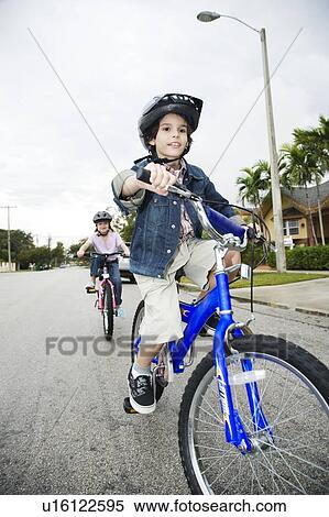 Two young children on bikes View Large Photo Image Stock Photography - Two young children on bikes. Fotosearch