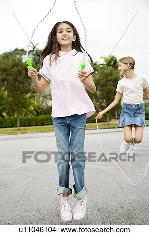 Picture - Two young girls skipping. Fotosearch