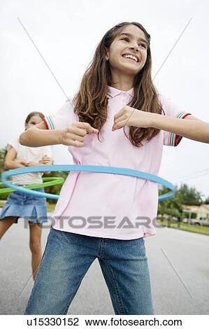 Stock Image - Two young girls with hoops. Fotosearch