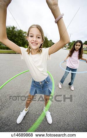 Stock Photo - Two young girls with hoops. Fotosearch