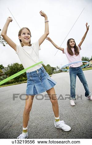 Two young girls with hoops View Large Photo Image Stock Photograph - Two young girls with hoops. Fotosearch
