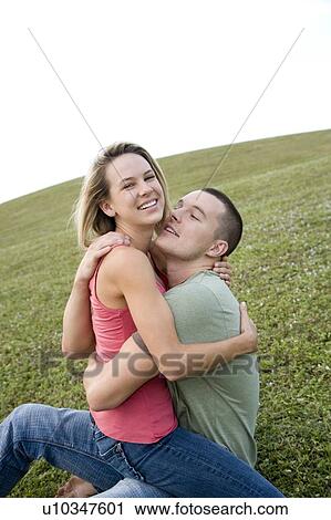 Two young lovers embracing View Large Photo Image Stock Image - Two young lovers embracing. Fotosearch