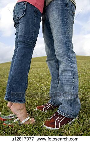 Two young lovers embracing View Large Photo Image Stock Photo - Two young lovers embracing. Fotosearch