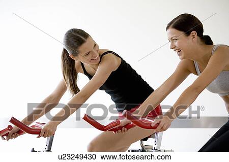 Stock Image - Two young women exercising. Fotosearch