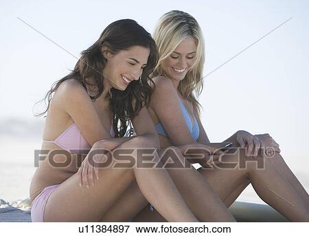 Stock Photo - Two young women in bikinis. Fotosearch