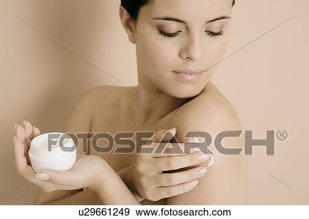Woman applying moisturising cream View Large Photo Image Stock Photo - Woman applying moisturising cream. Fotosearch