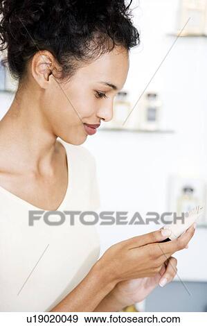Woman looking at moisturisers at the beauty counter View Large Photo Image Stock Photo - Woman looking at moisturisers at the beauty counter. Fotosearch