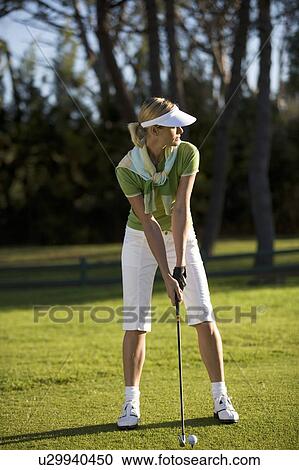Stock Image - Woman playing golf. Fotosearch