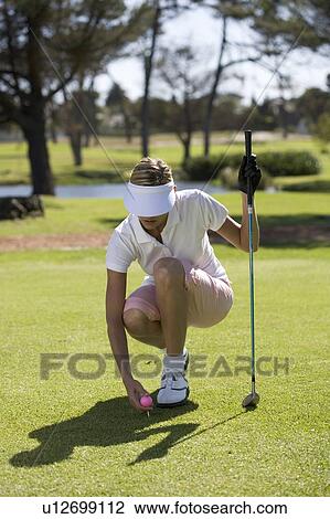 Woman playing golf, teeing up View Large Photo Image Stock Image - Woman playing golf, teeing up. Fotosearch