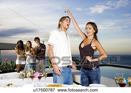 Woman pouring her drink over a man's head View Large Photo Image Stock Photo - Woman pouring her drink over a man's head. Fotosearch