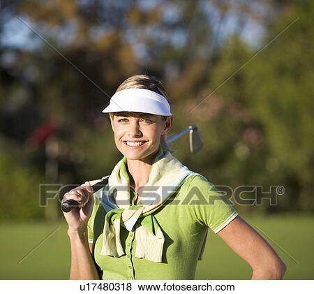 Stock Photo - Woman standing on a golf course. Fotosearch