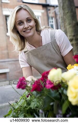 Woman tending to roses outside View Large Photo Image Stock Image - Woman tending to roses outside . Fotosearch