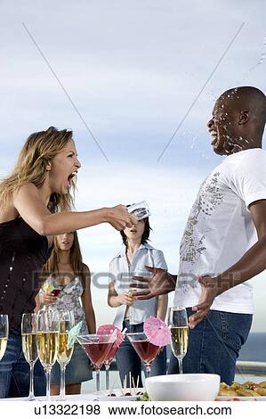woman throwing a drink over a man at party View Large Photo Image Stock Photo - woman throwing a drink over a man at party. Fotosearch