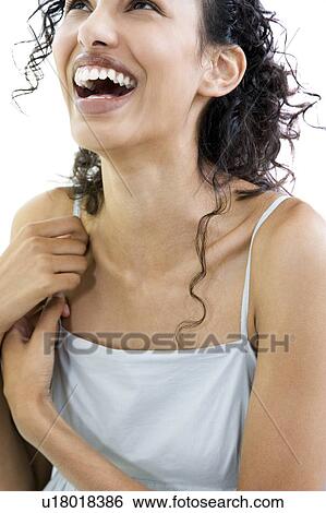 Woman trying on a sun top, smiling View Large Photo Image Stock Photograph - Woman trying on a sun top, smiling. Fotosearch