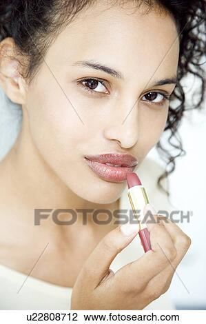 Woman trying on lipstick View Large Photo Image Stock Image - Woman trying on lipstick. Fotosearch