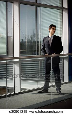 Stock Photo - Young businessman in modern office building. Fotosearch