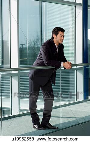 Stock Photo - Young businessman in smart, modern office. Fotosearch