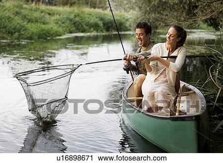 Young couple fishing View Large Photo Image Stock Image - Young couple fishing . Fotosearch