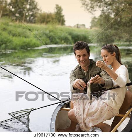Stock Image - Young couple fishing . Fotosearch