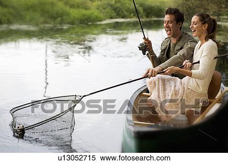 Young couple fishing View Large Photo Image Stock Photography - Young couple fishing . Fotosearch