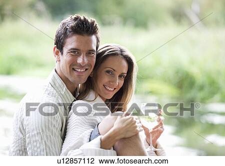 Stock Image - Young couple having a picnic. Fotosearch