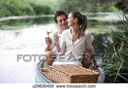 Stock Photo - Young couple having a picnic. Fotosearch