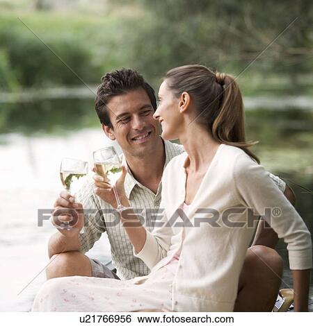 Stock Photograph - Young couple having a picnic. Fotosearch