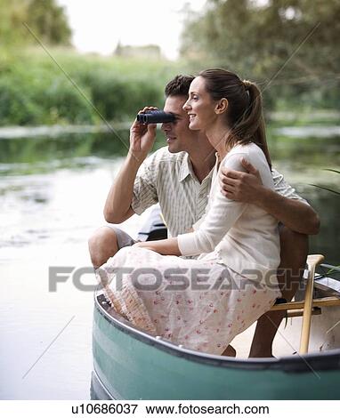Young couple in a rowing boat View Large Photo Image Stock Photo - Young couple in a rowing boat. Fotosearch