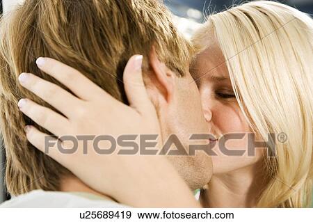 Stock Photo - Young couple kissing . Fotosearch