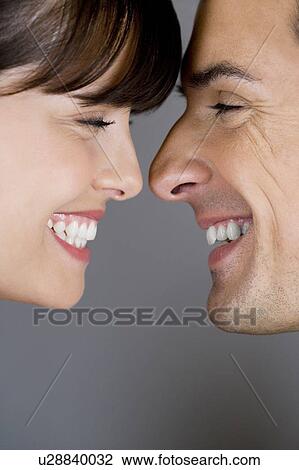 Young couple portrait, smiling and touching noses. View Large Photo Image Stock Image - Young couple portrait, smiling and touching noses. . Fotosearch