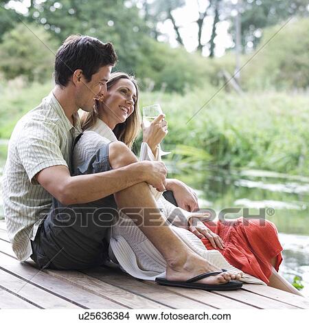 Young couple sitting in the sun View Large Photo Image Picture - Young couple sitting in the sun. Fotosearch