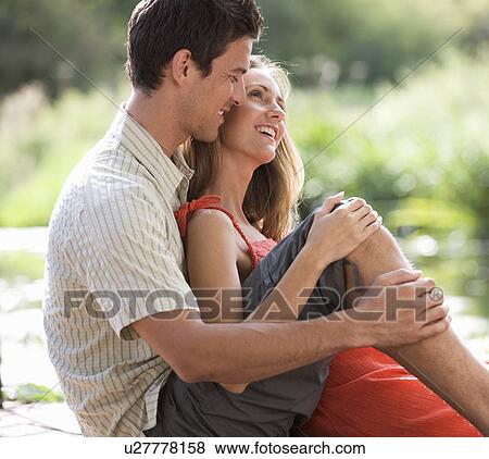 Young couple sitting in the sun View Large Photo Image Stock Photo - Young couple sitting in the sun. Fotosearch