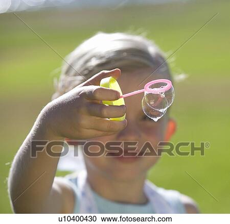 Young girl blowing bubbles View Large Photo Image Stock Image - Young girl blowing bubbles. Fotosearch