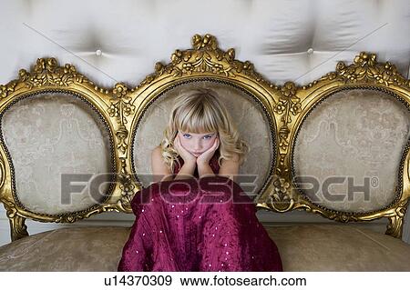 Stock Photo - Young girl in a party dress sulking. Fotosearch