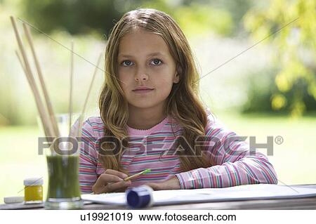 Stock Photo - Young girl painting. Fotosearch