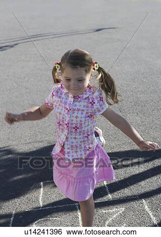 Young girl playing hopscotch View Large Photo Image Stock Photograph - Young girl playing hopscotch. Fotosearch